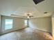 Spacious main bedroom with plush carpeting and tray ceiling is bathed in natural light at 6376 Sw 117Th Street Rd, Ocala, FL 34476
