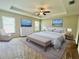 Spacious main bedroom features a tray ceiling, a ceiling fan and a dresser with lots of storage at 6376 Sw 117Th Street Rd, Ocala, FL 34476