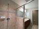 Modern walk-in shower with neutral tiles, glass partition, and contemporary fixtures at 6376 Sw 117Th Street Rd, Ocala, FL 34476