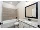 Full bathroom with a bathtub and shower combination, and a granite countertop single sink vanity at 7661 Somersworth Dr, Kissimmee, FL 34747