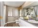 Bathroom featuring double sinks, a large mirror, and a shower with stylish curtain at 774 Ambleside Ave, Haines City, FL 33844