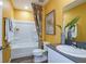 Bright bathroom featuring modern fixtures, a shower/tub combo, and colorful decor at 774 Ambleside Ave, Haines City, FL 33844