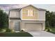 New construction, two-story home features a two-car garage, neutral color palette, and a welcoming covered front entry at 774 Ambleside Ave, Haines City, FL 33844
