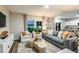 Cozy living room featuring modern decor, comfortable seating, and an open layout connecting to a kitchen and outdoor area at 774 Ambleside Ave, Haines City, FL 33844