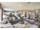 Open-concept living space with stylish furnishings, seamlessly blending the kitchen, dining, and living areas for modern living at 774 Ambleside Ave, Haines City, FL 33844