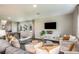 Inviting living room with modern decor and comfortable seating arrangements that lead to an adjacent dining area with backyard views at 774 Ambleside Ave, Haines City, FL 33844