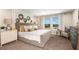 Serene main bedroom with large windows, plush bedding, and elegant decor at 774 Ambleside Ave, Haines City, FL 33844
