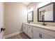 Bathroom with double vanity, granite countertop, modern fixtures and hardwood flooring at 7890 Somersworth Dr, Kissimmee, FL 34747