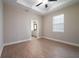 Comfortable bedroom with hardwood floors, a ceiling fan, and large window at 7890 Somersworth Dr, Kissimmee, FL 34747