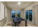 Dining room features modern decor, wood floors, and a sliding glass door to the outside at 1050 Foreshore Ln, Haines City, FL 33844