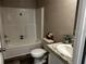 Clean bathroom with a shower and tub combo, granite vanity, and a toilet at 9494 Se 144Th Pl, Summerfield, FL 34491