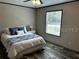 Comfortable bedroom with decorative pillows and natural light coming in through the window at 9494 Se 144Th Pl, Summerfield, FL 34491
