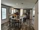 Bright open-concept kitchen with stainless appliances, an island with barstool seating, and a dining area at 9494 Se 144Th Pl, Summerfield, FL 34491