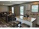 Open-concept kitchen with stainless steel appliances, granite countertops, and a central island with seating at 9494 Se 144Th Pl, Summerfield, FL 34491