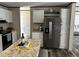Modern kitchen with white cabinets, stainless steel appliances, and an island with barstool seating at 9494 Se 144Th Pl, Summerfield, FL 34491