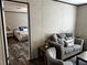 Cozy living room adjacent to a bedroom, featuring a comfortable sofa and stylish decor at 9494 Se 144Th Pl, Summerfield, FL 34491