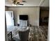 Open living space with a TV, console, and view to a bedroom at 9494 Se 144Th Pl, Summerfield, FL 34491