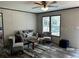 Cozy living room with comfortable seating, a stylish rug, and large windows for natural light at 9494 Se 144Th Pl, Summerfield, FL 34491