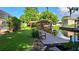 Beautiful backyard with a waterfront view and a wooden dock with a gazebo and a bench at 12430 Blue Heron Way, Leesburg, FL 34788