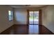 Bedroom with hardwood floors and sliding doors open to the pool at 12430 Blue Heron Way, Leesburg, FL 34788