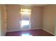 Cozy bedroom with window providing natural light, neutral paint and hardwood flooring at 12430 Blue Heron Way, Leesburg, FL 34788