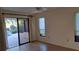 Bright room with ceiling fan and sliding glass doors leading to a screened lanai and pool at 12430 Blue Heron Way, Leesburg, FL 34788