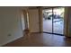 Bedroom with tile flooring and sliding glass door access to the screened pool area at 12430 Blue Heron Way, Leesburg, FL 34788