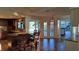 Spacious kitchen with granite counters, breakfast bar, and access to outdoor pool area at 12430 Blue Heron Way, Leesburg, FL 34788