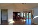 Open living room with tiled floor, vaulted ceilings, with a kitchen and backyard at 12430 Blue Heron Way, Leesburg, FL 34788
