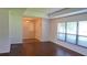 Bright living room with hardwood floors and a large window with blinds at 12430 Blue Heron Way, Leesburg, FL 34788