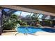 Relaxing screened-in pool area featuring lush landscaping and tranquil views at 12430 Blue Heron Way, Leesburg, FL 34788