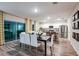 Open-concept dining area with white cabinets, stainless steel appliances, and stylish decor at 1609 Sage Ave, Haines City, FL 33844