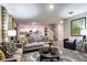 Bright living room with stylish furnishings, a decorative rug, and an open staircase at 1609 Sage Ave, Haines City, FL 33844