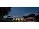 Backyard view of the home's in-ground pool, outdoor seating, and covered patio with lighting at 3610 Amber Ln, Lakeland, FL 33812