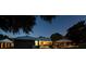Backyard view of the home's in-ground pool, outdoor seating, and covered patio with lighting at 3610 Amber Ln, Lakeland, FL 33812