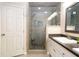 Bathroom with a walk-in shower, single sink, and vanity with granite countertops at 3610 Amber Ln, Lakeland, FL 33812