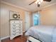Comfortable bedroom with a ceiling fan, hardwood floors, and plenty of storage at 3610 Amber Ln, Lakeland, FL 33812