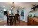 Charming dining area with dark wood table, cabinet, decorative lighting, and door to backyard at 3610 Amber Ln, Lakeland, FL 33812