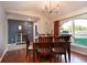 Cozy dining area with dark wood furniture, stylish lighting, and an arched window view at 3610 Amber Ln, Lakeland, FL 33812