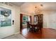 Elegant dining room featuring a wooden table set, a decorative chandelier, and a large window at 3610 Amber Ln, Lakeland, FL 33812