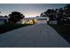 Charming home featuring a long driveway leading to a two-car garage with decorative doors and stone archway at 3610 Amber Ln, Lakeland, FL 33812