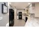 Modern kitchen with white cabinets, granite countertops, black appliances, and tile flooring at 3610 Amber Ln, Lakeland, FL 33812