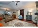 Open living room with a decorative rug, a ceiling fan and sliding barn door entrance at 3610 Amber Ln, Lakeland, FL 33812