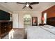 This main bedroom has hardwood floors, a ceiling fan and an attached bathroom at 3610 Amber Ln, Lakeland, FL 33812
