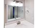 This bathroom offers a modern lighting fixture, framed mirror, and vanity at 6255 Christina Ct, Orlando, FL 32810
