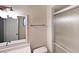 Bathroom featuring a shower with glass doors, framed mirror, and modern lighting fixture at 6255 Christina Ct, Orlando, FL 32810
