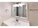 This bathroom offers a modern lighting fixture, framed mirror, and vanity at 6255 Christina Ct, Orlando, FL 32810
