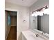 Bathroom with sink, mirror, and lighting fixture with view to adjacent bedroom at 6255 Christina Ct, Orlando, FL 32810