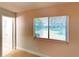 This bedroom offers neutral paint, tile flooring, and a window for natural light at 6255 Christina Ct, Orlando, FL 32810
