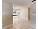 Open dining area featuring neutral walls, tile flooring, and a view of the outdoor patio at 6255 Christina Ct, Orlando, FL 32810